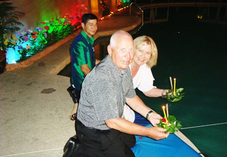 A loving couple prepares to loy their krathong at the Montien Hotel.