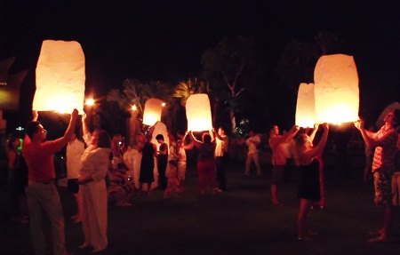 Guests at the Centara Grand Mirage Beach Resort light their khomloys and prepare to send them skyward, taking away bad luck for the coming year.