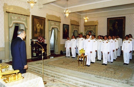 HM King Bhumibol Adulyadej calls for the new government to make peace its priority during a swearing-in ceremony at Chitralada Palace in Bangkok Monday, Dec. 22, 2008. Prime Minister Abhisit Vejjajiva, standing front row, and his cabinet members listen intently.