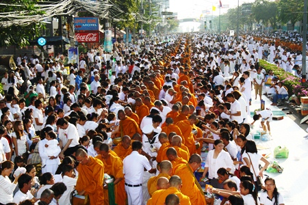 Thousands of devout Buddhists and people of many faiths join in the merit making ceremonies along North Pattaya Road.