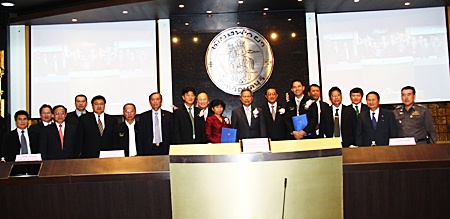 City and national officials pose for a commemorative photo after signing a memorandum of understanding for an automated traffic control system. 