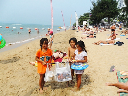 Three young beachcombers help to keep the place clean. 