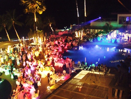 Hundreds of guests gather around the pool to ring in the New Year at Pullman Pattaya Aisawan Resort & Spa.