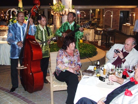 The Los Cuerdas Trio from the Philippines entertains guests at the Moon River Pub.