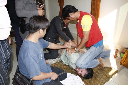 Police and friends bring the Turkish mugger under control inside the massage parlor.