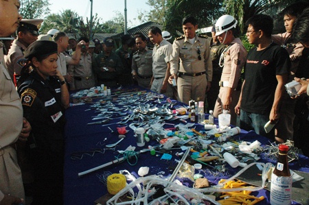 Officials gather around some of the illegal contraband confiscated during the pre-New Year sweep. 