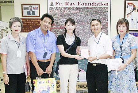Ms. Midori Kawaguchi (third left), from the Nippon Telegraph and Telephone Public Corporation, presents a donation to Father Peter Srivorakul C.Ss.R. (third right), President of the Father Ray Foundation, to help provide daily necessities to the 850 children and students with disabilities currently living and being educated at the Father Ray Foundation in Pattaya.  Also present were Boonthavee Klinsukon (first left), director of the Father Ray Day Care Center, Hideki Shizuka, Managing Director of Yoshinoki Co., Ltd. (second left), and Somnuk Phao-Ngon (first right), Customer Relations Manager at the Father Ray Foundation.