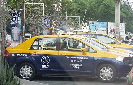 Metered taxis line up to wait for customers.