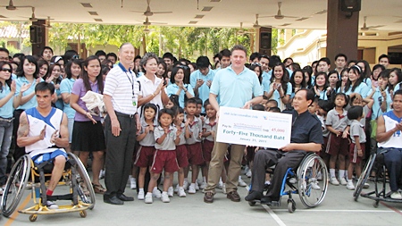 Brett Hayes, general manager for Thailand and Vietnam of Invida (Thailand) led his staff of 340 people to visit the Father Ray Foundation recently, where they received a warm welcome by the children under the care of the centre. They were treated to a game of wheelchair basketball played by handicapped students of the Redemptorist Vocational School.  Mr. Hayes presented 45,000 baht to Udomchoke Choorat, director of the school. In addition Invida also sponsored foundation t-shirts valued at 8000 baht.