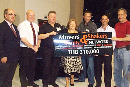 Tracy Cosgrove happily receives a donation to the Melisa Cosgrove Foundation raised in a joint effort by the lighthouse Club Pattaya, BCCT and AustCham.