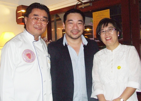 Pascal (left) and Kim (right) welcome Koh Mr. Saxman to the restaurant’s 10th anniversary celebration.