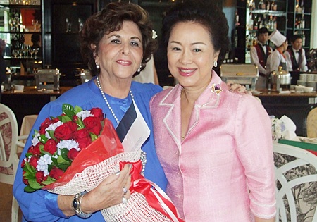 Khun Panga presents Arlette with a bouquet of red roses.