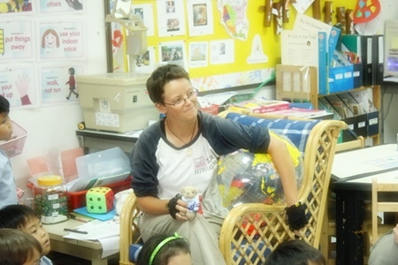 Catherine and Mee Nooi, a bear that travelled with her on the trip, answering questions at Garden International School.