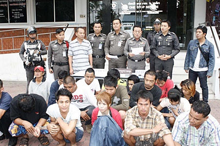 The alleged drug dealers are detained at Banglamung Police Station as the charges are read out.