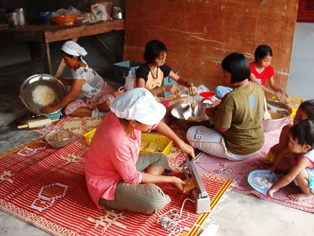 The three ladies who survived the tsunami, but lost their business, process the herbs which have been dried in their new herb dryer.