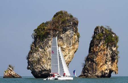 Multihull “Miss Saigon” cruises past some limestone outcrops during Race Day 1 of The Bay Regatta. (Photo/www.acyc-phuket.com).