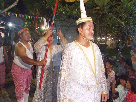 The head deity leads the procession to inspect the food on offer.