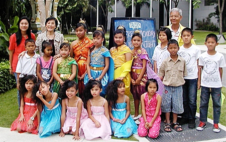 Toy (rear, 2nd from left) and staff of Pattaya Orphanage pose with the their ‘angels’.
