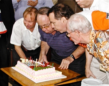 Founding member Preben, Michel de Goumis (Current Chairman), and former Chairmen Drew Noyes and Richard Smith make short work of blowing out the candles.