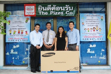 Tic (second right) receives the Little Duck Nursery’s new television. 