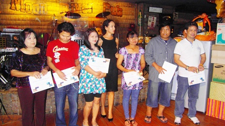 Employees receive their service awards at the staff party held April 4 at the Moon River Pub.