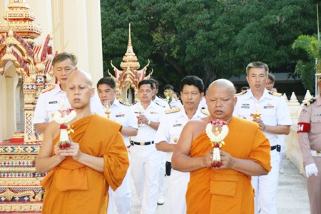 Revered monks lead officers and enlisted men around the temple at the Sattahip Naval Base.