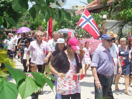 Norwegians parade through the streets, waving the Norwegian flag.