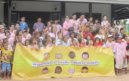 Bridge Club members and youngsters from the Child Protection and Development Center pose for a commemorative photo.