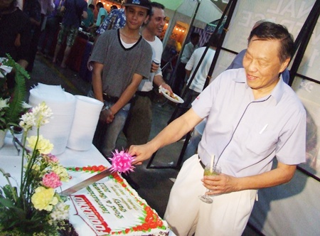 Edwin Lim cuts the colourful cake declaring the festival open.