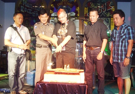 Mathew “Matty” Carley (center), Hard Rock Cafe manager, and honored guests cut the birthday cake.