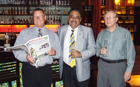 Robert flips through the Pattaya Mail presented to him by the publisher Peter Malhotra (centre). Bruce Hoppe (right), VP of Asia Operations Emerson was guest of honour to celebrate the American Independence Day.