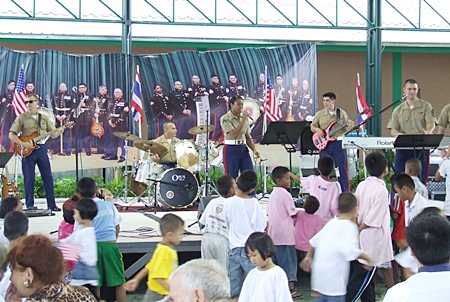 The U.S. Marine Corp band has everyone on their feet and dancing. 