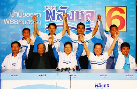 Palang Chon party members raise their hands in victory after winning 6 of 8 seats in Chonburi province.