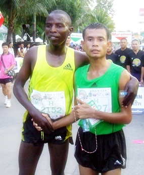Men’s half-marathon winner Thailand’s Sanchai Namket (right) is congratulated by runner-up John Murikic Mwangi of Kenya.