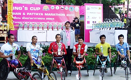 The wheelchair athletes proudly show off their trophies. The winner of the event, Prawat Wahoram, is far left of picture.