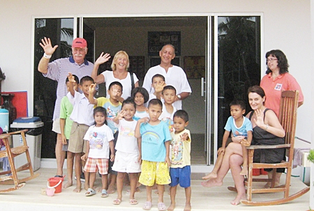 John & Wendy Khan (center) of “We2R1” will be performing Live 60s and 70s music for the Mercy Center Children’s Home Grand Opening. Also shown are Mercy family members in front of their “Forever” Home Baan Khong Por in Pong.