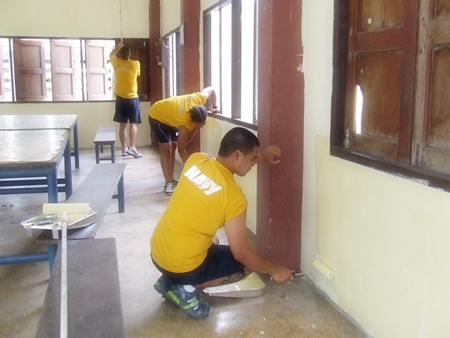 Sailors from the USS Cowpens apply a new coat of paint to the walls at Ban Thungkrad School in Banglamung.