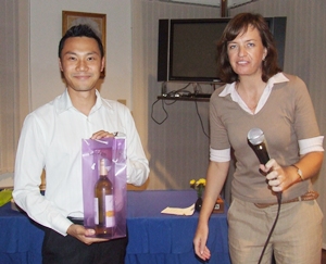 The lucky winner of the name card draw receives his prize from Belinda Skinner. 