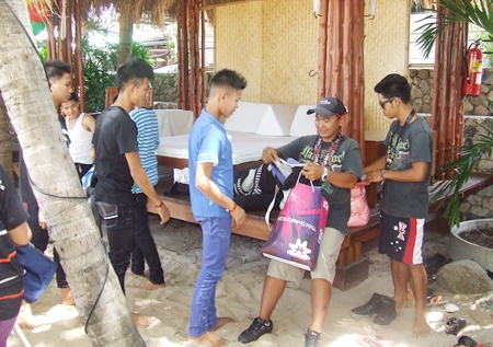 Boys line up to receive their swim trunks.