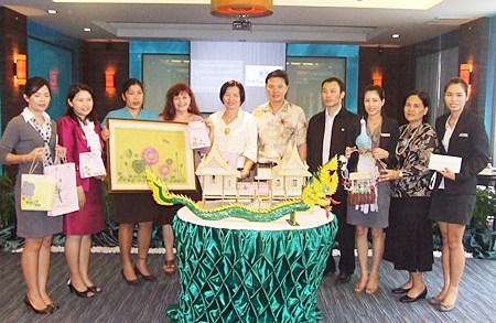 Siam Bayview’s technical department won first prize with their Traditional Thai house (center).  Housekeeping took second place with a framed artwork of a bed of flowers (left), and the Accounting Department’s figure of a mythical phoenix (right) won third place.
