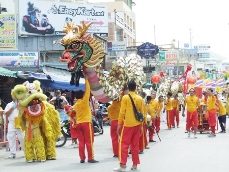Lions and dragons make their way up Walking Street. (Photo by Phasakorn Channgam) 