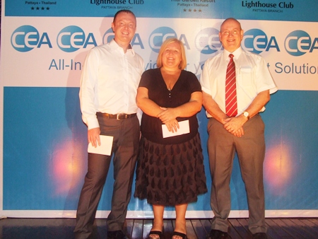 Tracy Cosgrove receives 20,000 baht from Scott Tierney and Graham Macdonald of MBMG.