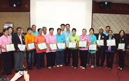 Mayor Itthiphol Kunplome (center) poses with members of the community that received plaques for their efforts to adhere to HM the King’s “sufficiency economy” philosophy. 
