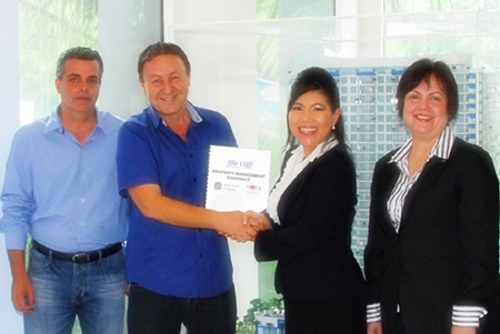 Rony Fineman, President of The Nova Group (2nd left), and Suphin Mechuchep, Managing Director of Jones Lang LaSalle (3rd left), exchange the property management contract for The Cliff.  Also present at the contract signing ceremony were Mr. Kobi Elbaz, Director of The Nova Group (far left), and Rajneeporn Bishop, Head of Residential of Jones Lang LaSalle (right). 