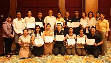 Employees of the Centara Grand Mirage Beach Resort Pattaya, under the watchful eye of Lily Eduardcoce (standing left) the training manager, pose proudly with their certificates of achievement at the end of their successful training sessions. Andre Brulhart (standing 5th left), the general manager, presented his staff with their recognitions, thanking them for their dedication for excellence in five star services.