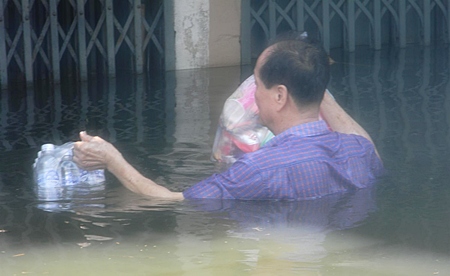 Emergency supplies help this man wait out the flooding in Bangkok.