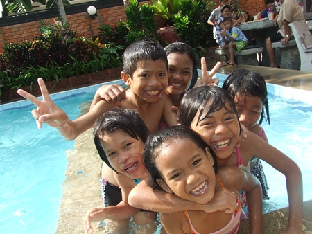 Children are having a great time enjoying the pool.