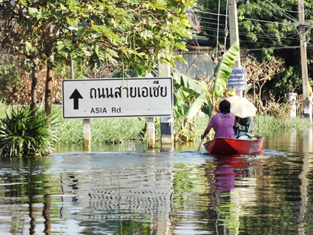 A quiet paddle up Asia Road - Lifestyles of the residents have completely changed because of the flood.