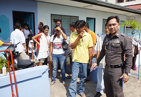 Pol. Lt. Col. Nanthawut Suwanla-Ong leads the gamblers out of the rented house. 