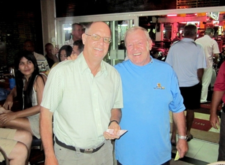 Brian Gabe (left) was glad he bought a ticket as he accepts the 50/50 prize from PSC Golf Chairman, Joe Mooneyham.